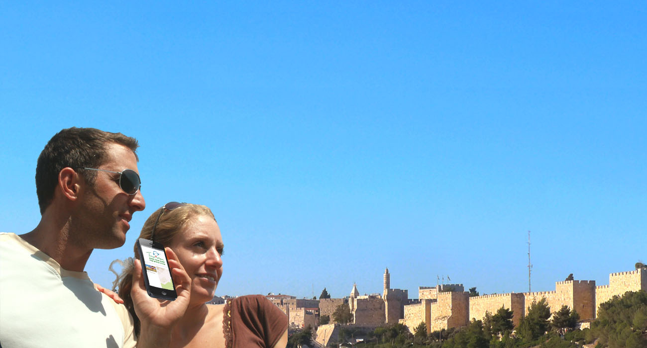 A couple in Jerusalem holding a smartphone and listening to it